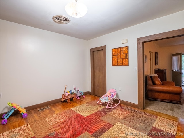 game room with wood-type flooring