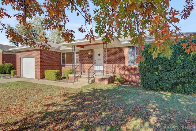 view of front of property with a front yard and a garage