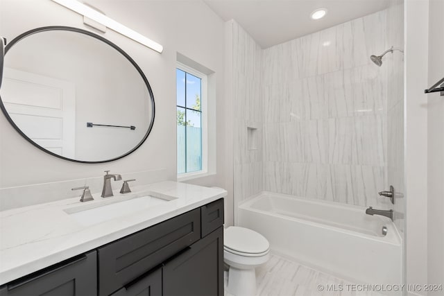 full bathroom with vanity, toilet, and tiled shower / bath