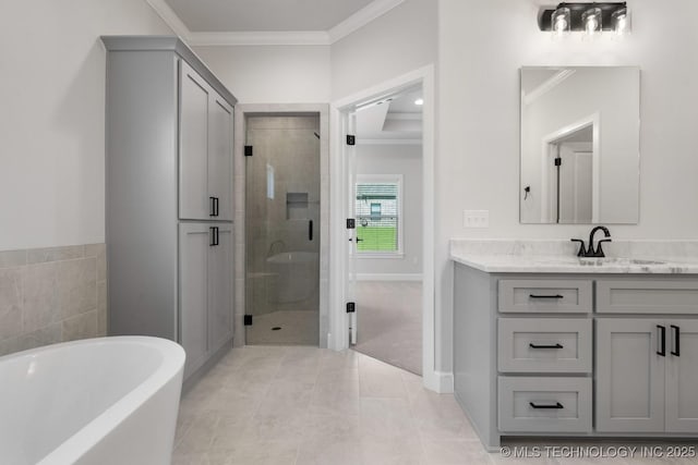 3908 S Elder Blvd, Broken Arrow, OK 74012 - bathroom with vanity, a shower stall, crown molding, a freestanding bath, and baseboards