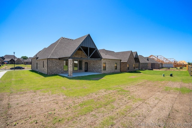 3908 S Elder Blvd, Broken Arrow, OK 74012 - rear view of house featuring a yard, a patio, board and batten siding, and brick siding