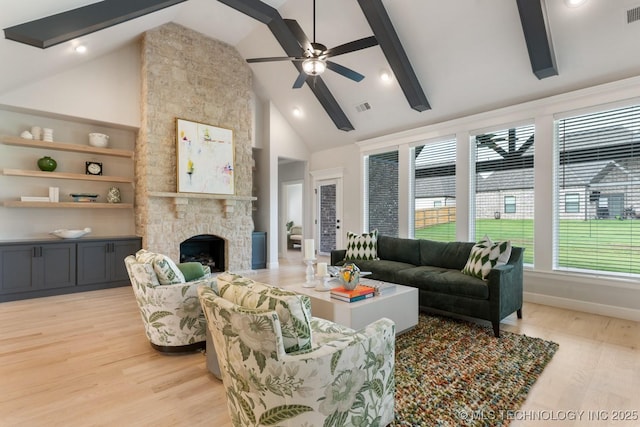 3908 S Elder Blvd, Broken Arrow, OK 74012 - living room with high vaulted ceiling, light wood-style floors, a stone fireplace, ceiling fan, and beam ceiling