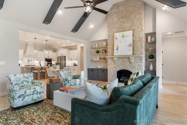 3908 S Elder Blvd, Broken Arrow, OK 74012 - living area featuring high vaulted ceiling, ceiling fan, light wood-style flooring, built in shelves, and a fireplace