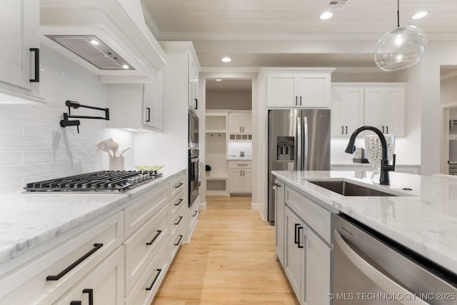 3908 S Elder Blvd, Broken Arrow, OK 74012 - kitchen with appliances with stainless steel finishes, premium range hood, white cabinets, tasteful backsplash, and recessed lighting