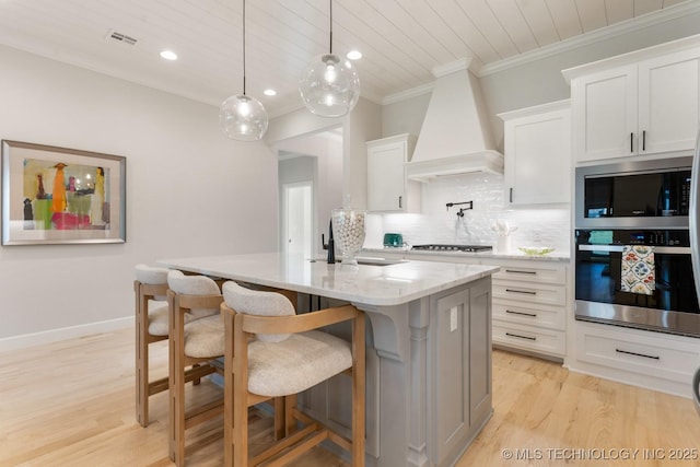 3908 S Elder Blvd, Broken Arrow, OK 74012 - kitchen with stainless steel appliances, premium range hood, tasteful backsplash, ornamental molding, and a center island with sink