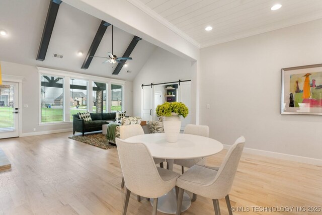 3908 S Elder Blvd, Broken Arrow, OK 74012 - dining area with a barn door, plenty of natural light, a ceiling fan, beamed ceiling, and light wood finished floors
