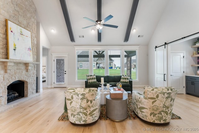 3908 S Elder Blvd, Broken Arrow, OK 74012 - living area with ceiling fan, a barn door, high vaulted ceiling, beam ceiling, and light wood-style floors