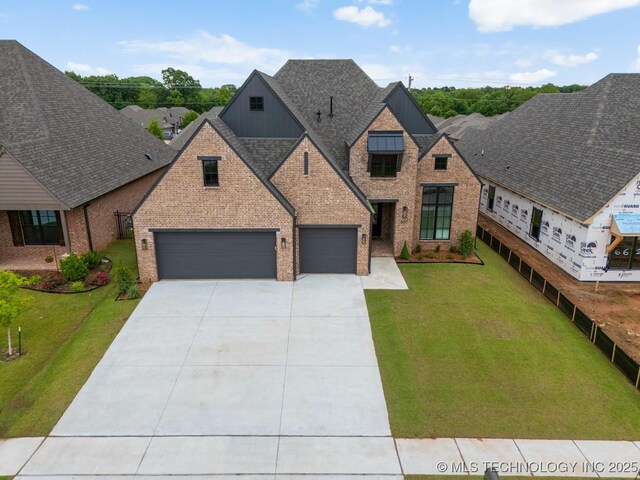 6617 S Fir Ave, Broken Arrow, OK 74134 - view of front of house featuring driveway, a front yard, board and batten siding, brick siding, and a shingled roof
