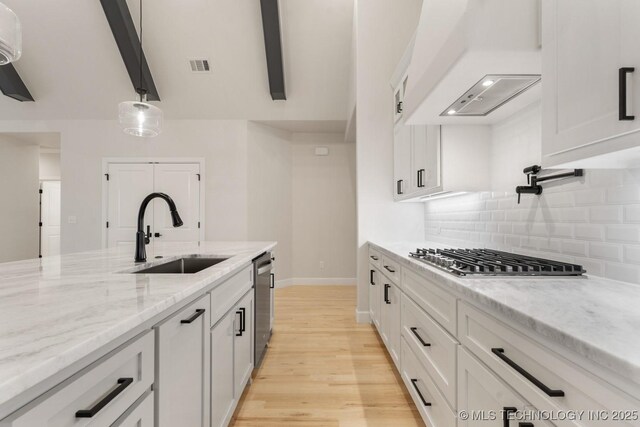 6617 S Fir Ave, Broken Arrow, OK 74134 - kitchen with a sink, appliances with stainless steel finishes, white cabinetry, tasteful backsplash, and beamed ceiling