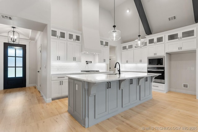 6617 S Fir Ave, Broken Arrow, OK 74134 - kitchen featuring stainless steel appliances, white cabinets, tasteful backsplash, baseboards, and high vaulted ceiling