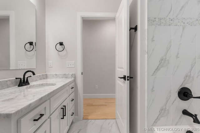 6617 S Fir Ave, Broken Arrow, OK 74134 - bathroom featuring marble finish flooring, vanity, baseboards, and a shower
