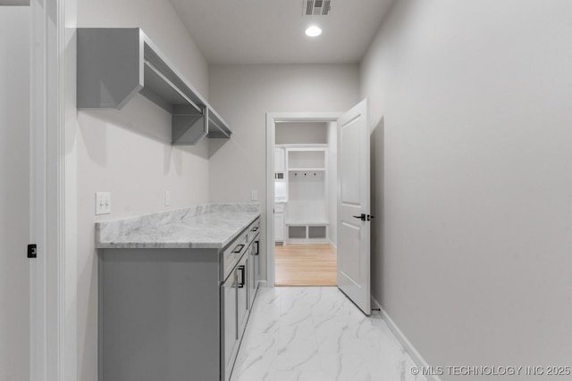 6617 S Fir Ave, Broken Arrow, OK 74134 - laundry room with light marble finish floors and baseboards
