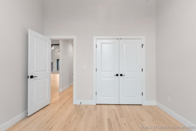 6617 S Fir Ave, Broken Arrow, OK 74134 - unfurnished bedroom with light wood-style floors, baseboards, and a closet