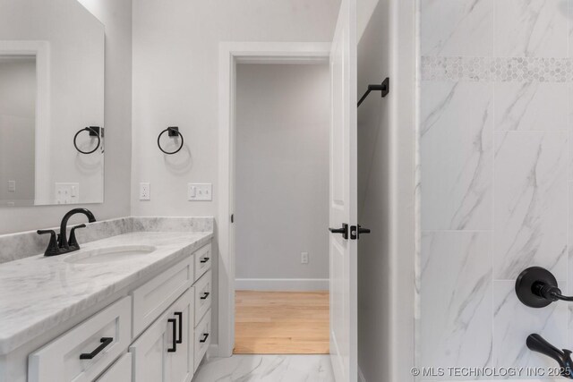 6617 S Fir Ave, Broken Arrow, OK 74134 - bathroom with vanity, marble finish flooring, baseboards, and a shower