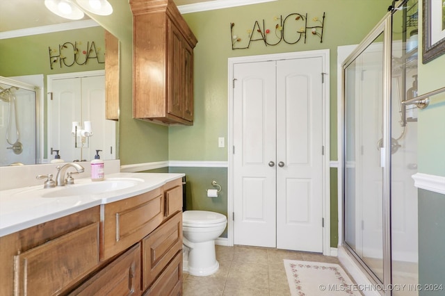 bathroom featuring tile patterned flooring, vanity, and a shower with door