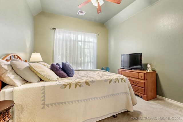 bedroom featuring lofted ceiling, light colored carpet, and ceiling fan