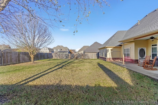 view of yard featuring a patio area and ceiling fan