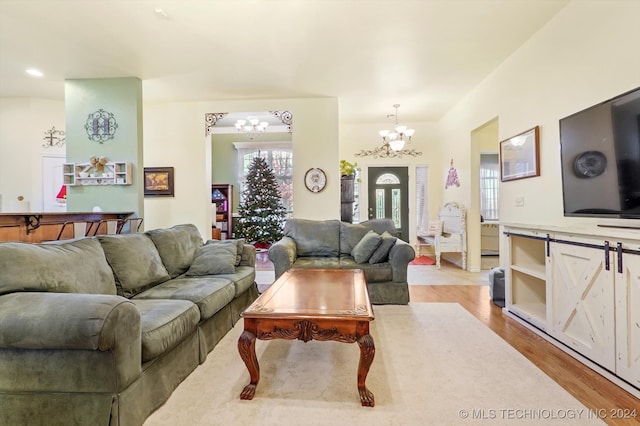 living room featuring light hardwood / wood-style flooring and a chandelier