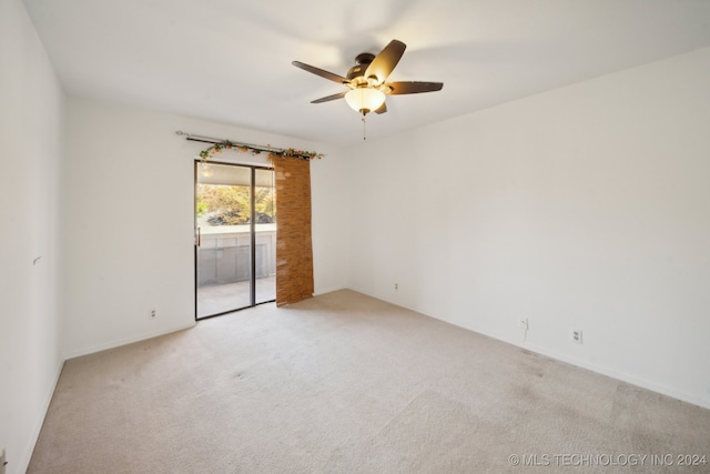 empty room featuring ceiling fan and light carpet