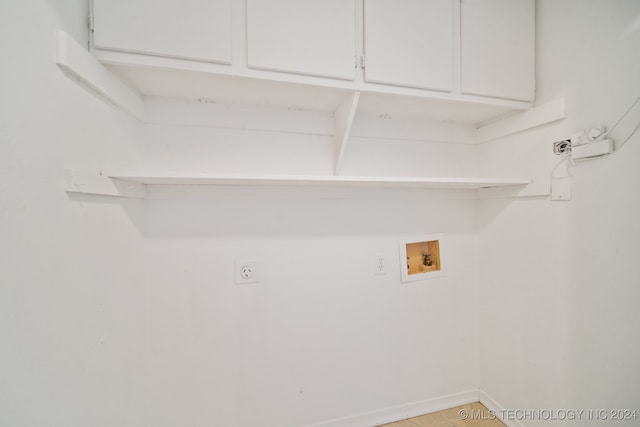 laundry room featuring cabinets, hookup for a washing machine, and electric dryer hookup