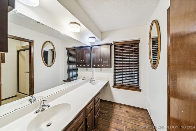 bathroom with a textured ceiling and vanity