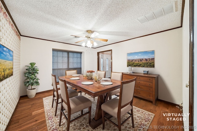 dining area featuring ceiling fan, wood-type flooring, and a textured ceiling