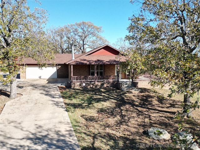 view of front of home with a porch and a garage