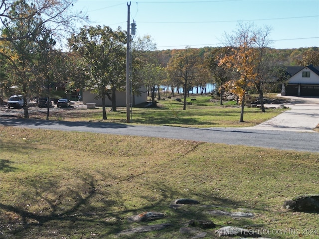 view of yard featuring a water view and a garage