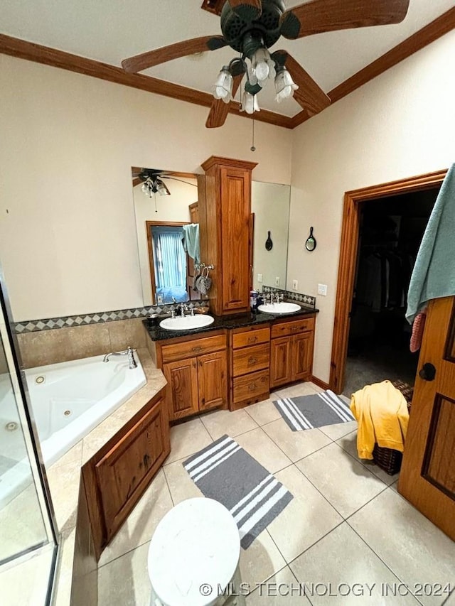 bathroom featuring tile patterned floors, vanity, crown molding, and tiled tub