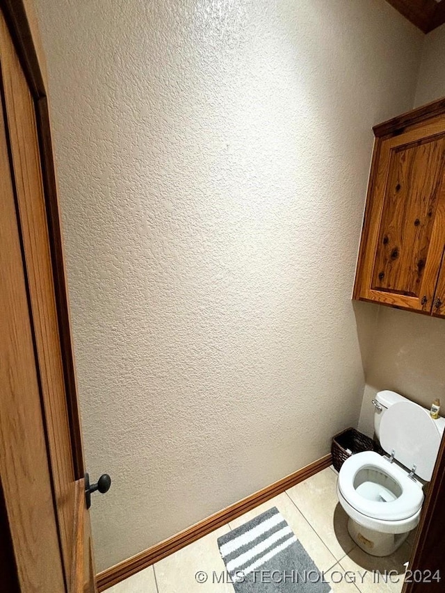 bathroom with tile patterned floors and toilet