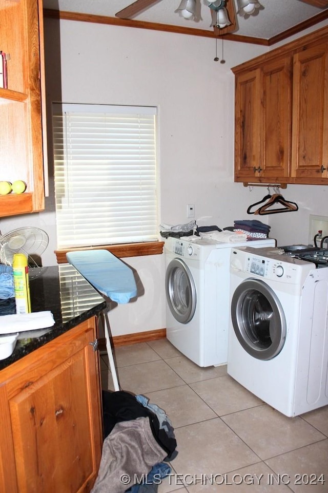 laundry room featuring ceiling fan, cabinets, washer and clothes dryer, light tile patterned floors, and ornamental molding