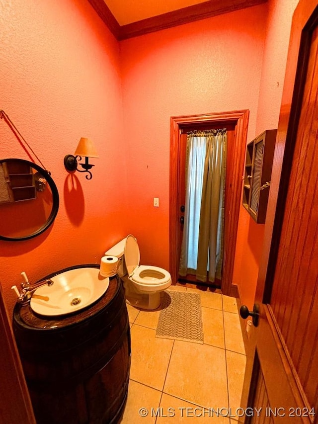 bathroom with tile patterned flooring, vanity, toilet, and ornamental molding