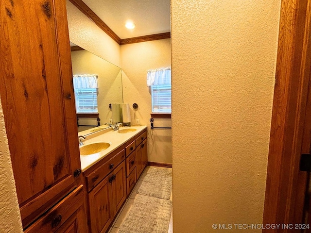 bathroom featuring tile patterned floors, crown molding, plenty of natural light, and vanity