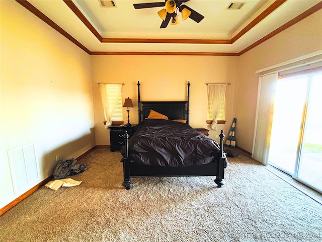 carpeted bedroom with access to exterior, a raised ceiling, ceiling fan, and ornamental molding