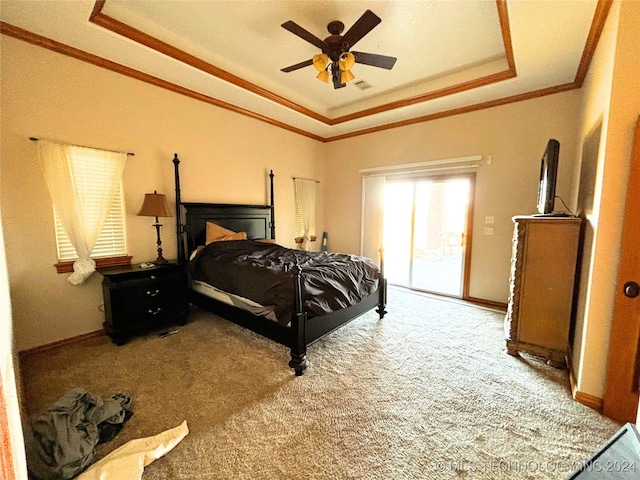 bedroom featuring access to exterior, carpet flooring, ornamental molding, a tray ceiling, and ceiling fan