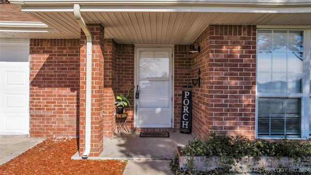 doorway to property with a garage