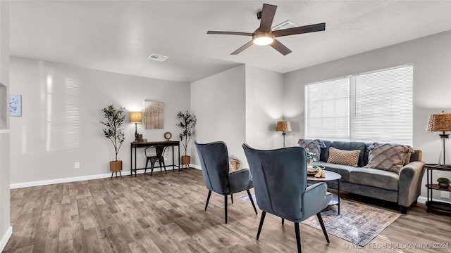 living room with ceiling fan and light hardwood / wood-style floors