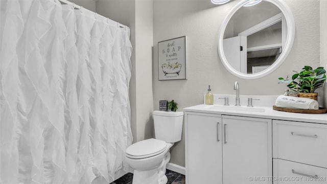 bathroom featuring vanity and toilet