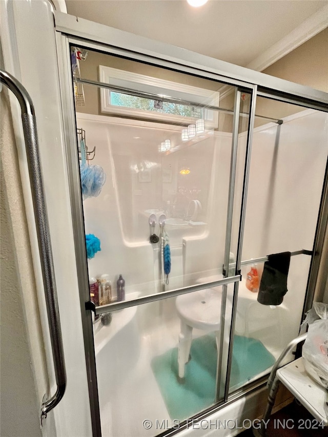 bathroom featuring walk in shower and ornamental molding