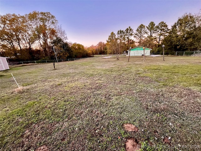 view of yard at dusk