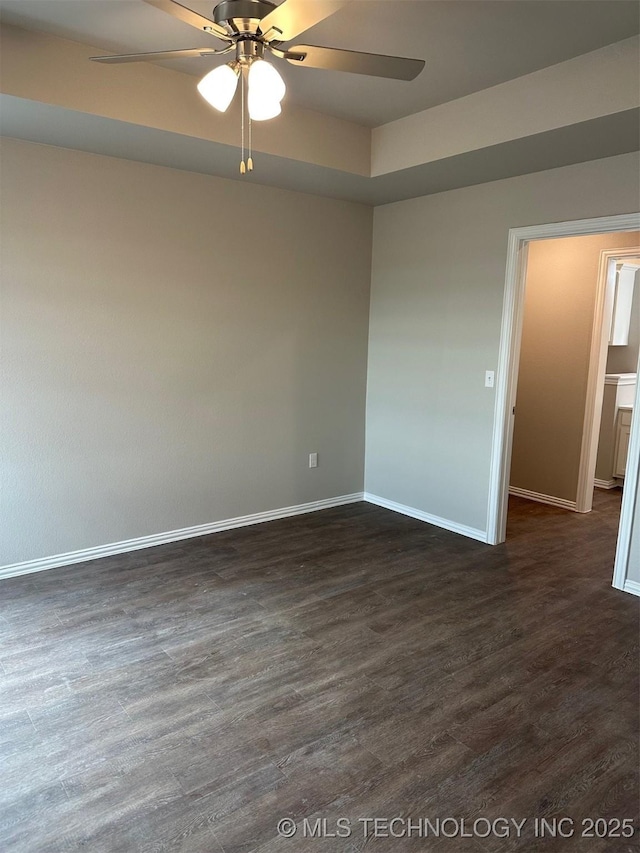 unfurnished room with ceiling fan and dark hardwood / wood-style flooring