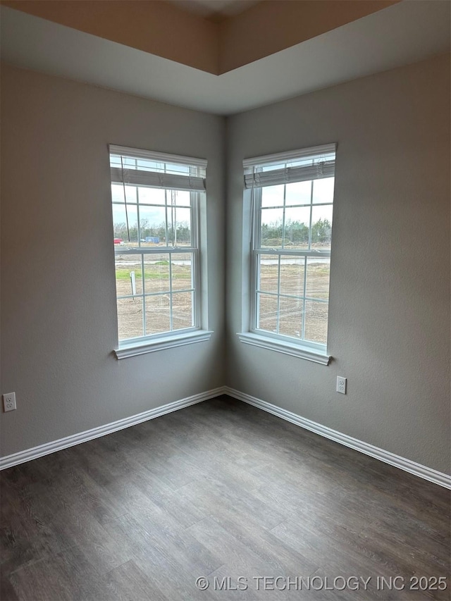 unfurnished room featuring dark hardwood / wood-style flooring