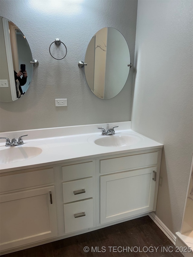 bathroom featuring hardwood / wood-style flooring and vanity