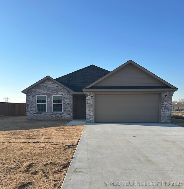 ranch-style home featuring driveway, brick siding, and an attached garage