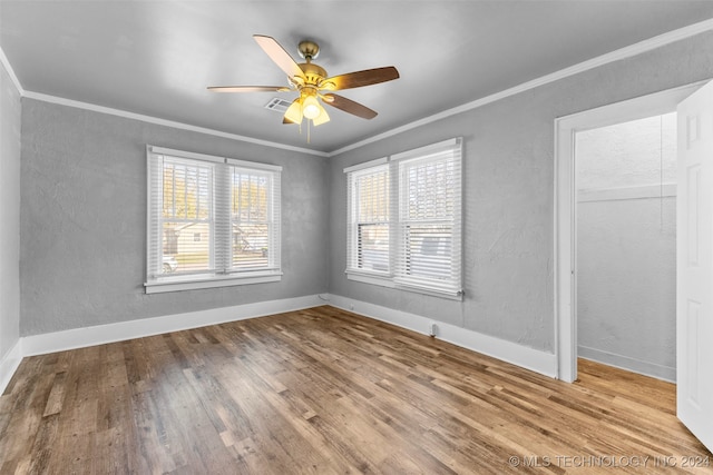 spare room featuring light hardwood / wood-style flooring, ceiling fan, and ornamental molding