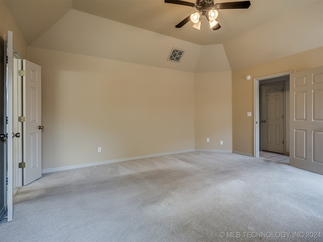 carpeted empty room featuring ceiling fan and lofted ceiling