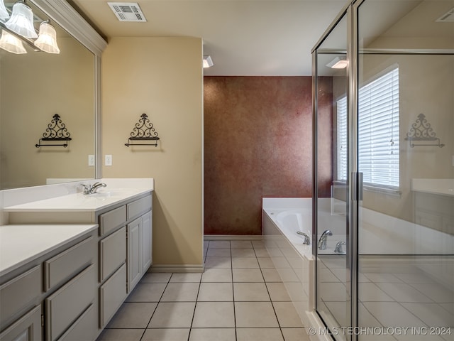 bathroom featuring tile patterned flooring, vanity, and shower with separate bathtub