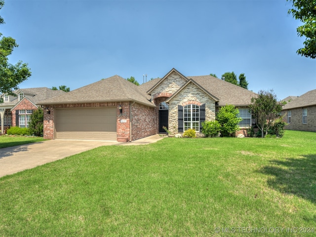 single story home with a front yard and a garage