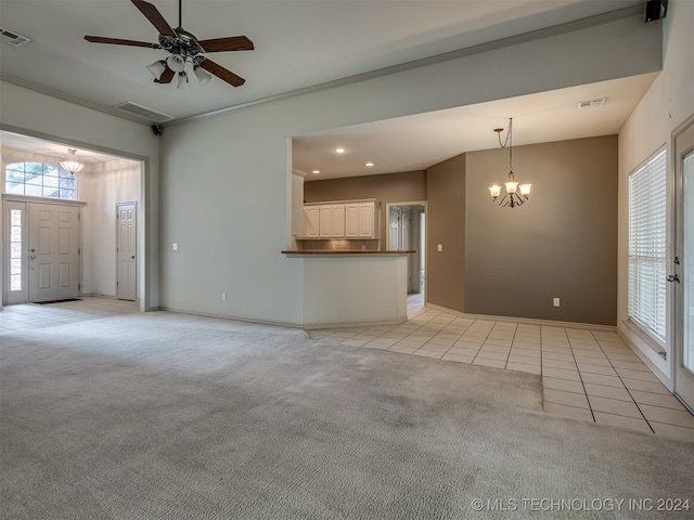 unfurnished living room featuring light tile patterned flooring and ceiling fan with notable chandelier