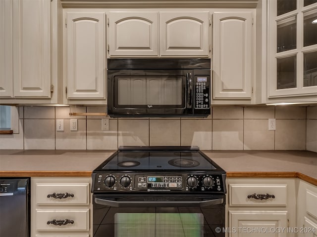 kitchen with decorative backsplash, white cabinetry, and black appliances